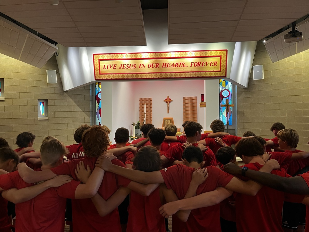 Soccer Program praying together in our De La Salle Chapel.